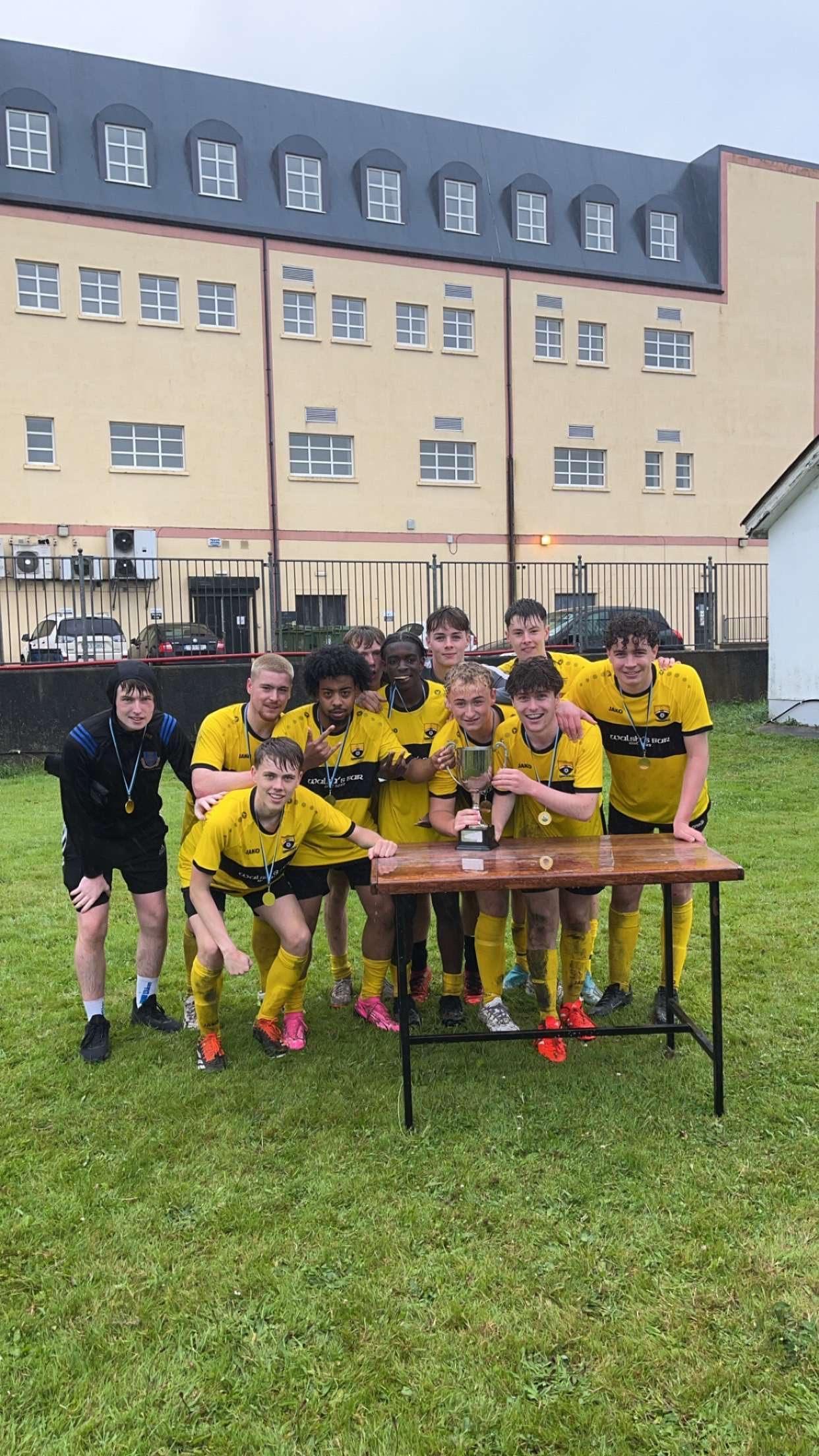 Winning team celebrating with the trophy after the six-aside tournament
