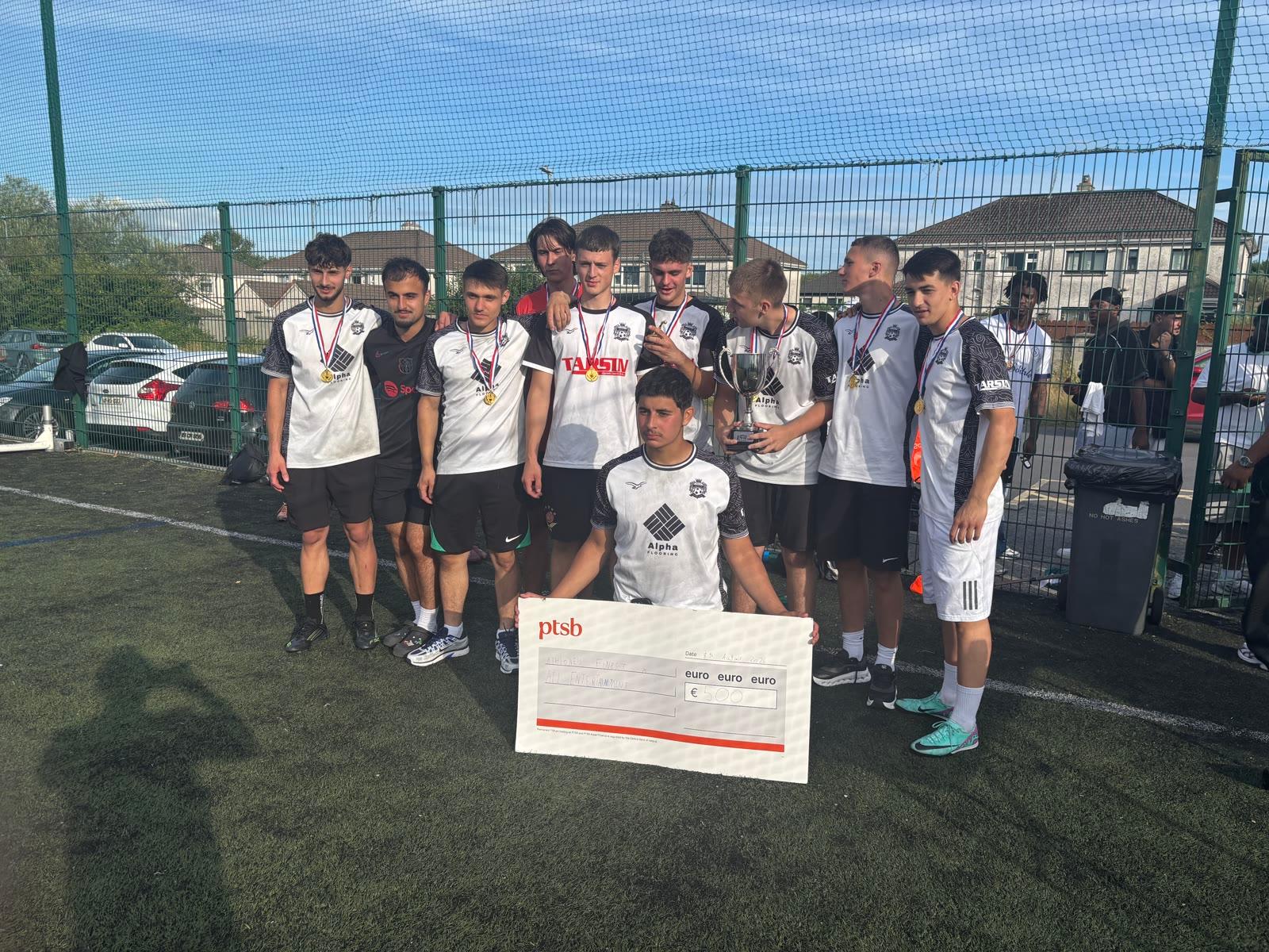2026 tournament winners holding the cup and giant cheque