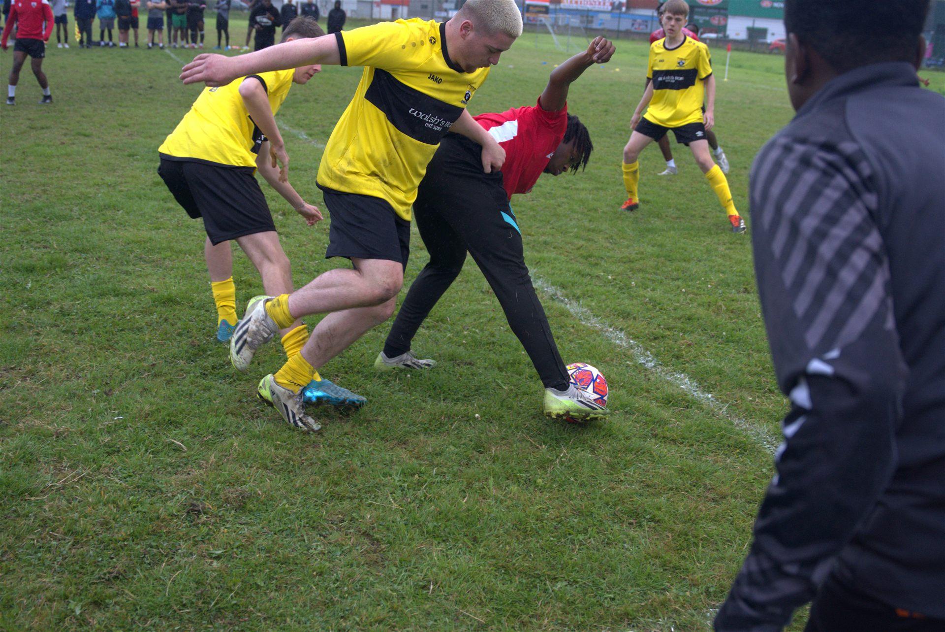 Athlone's Finest players in yellow kit in front of the watching crowd